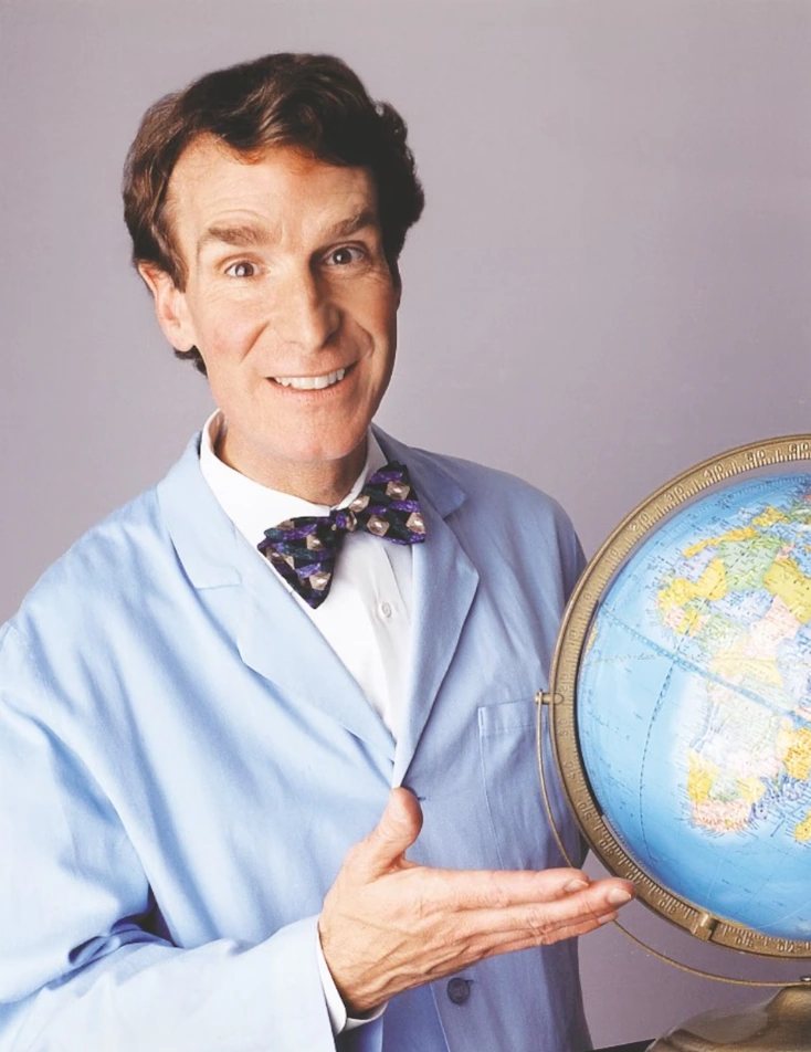 Bill Nye the Science Guy in his lab coat and bow tie, holding a globe